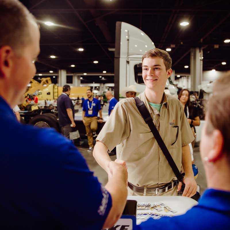 Photo of a student shaking hands with a business partner.