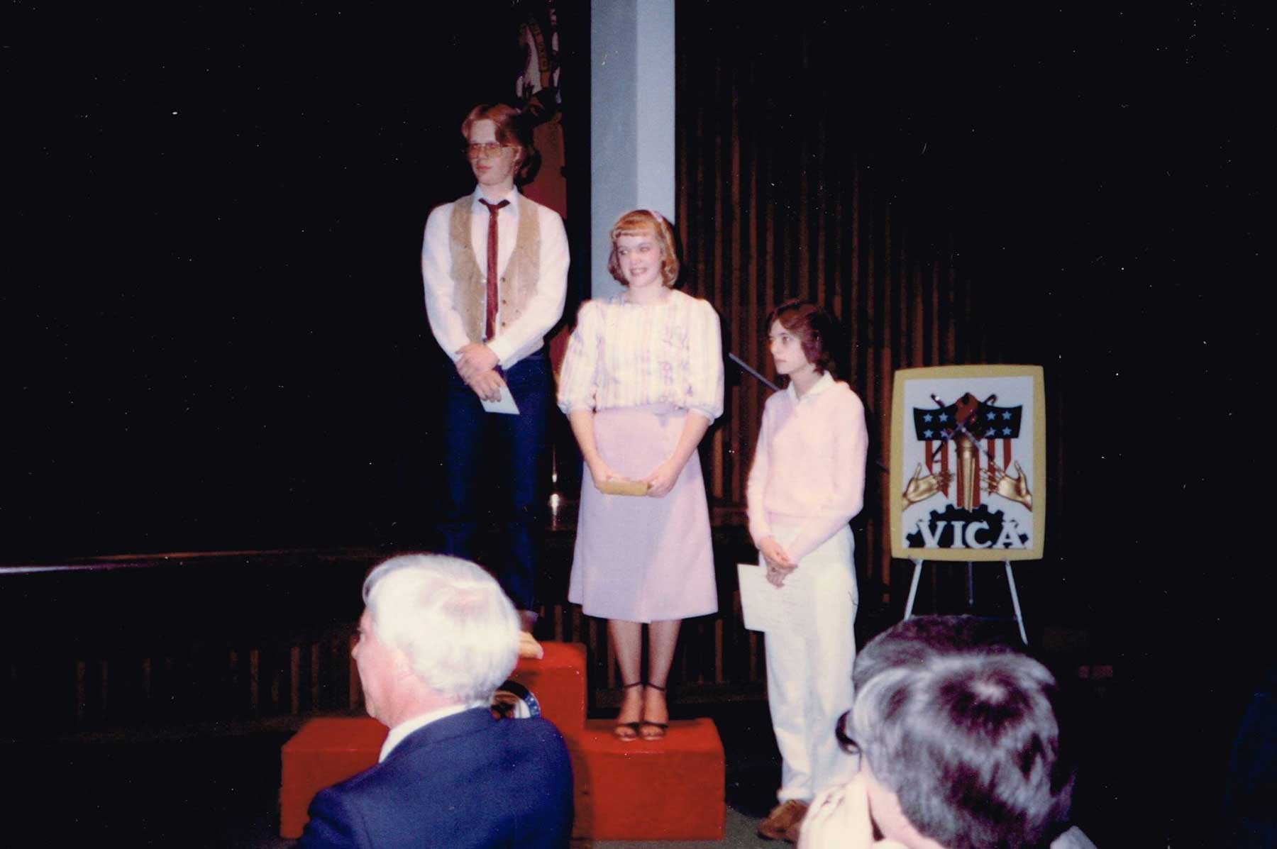 Three VICA students on medalist podium.}