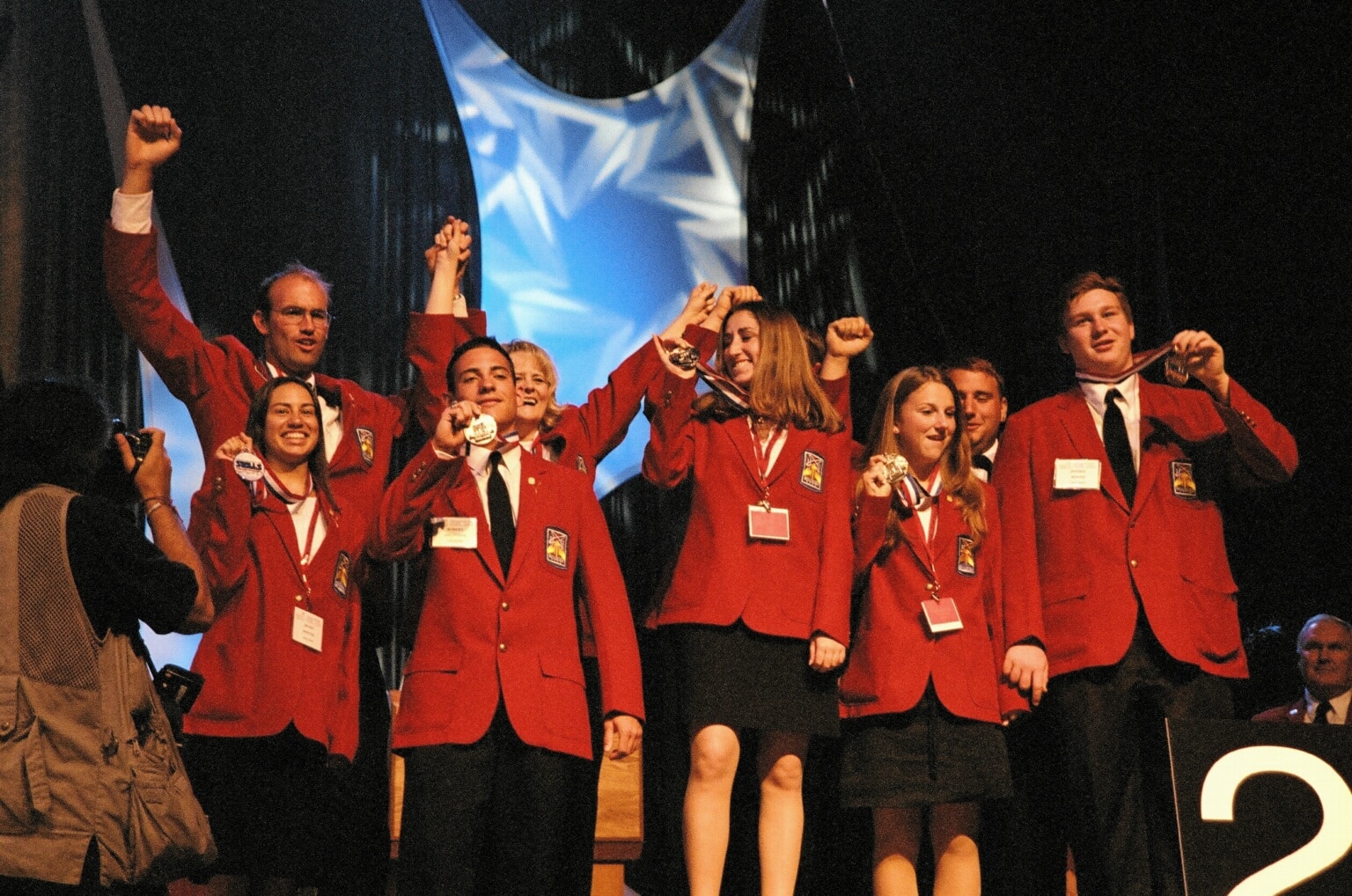 Several students on a medalist podium during SkillsUSA's national conference.}