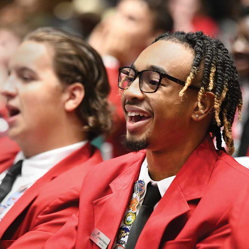 Two male students in SkillsUSA official dress laughing