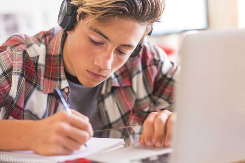 Boy writing in a notebook