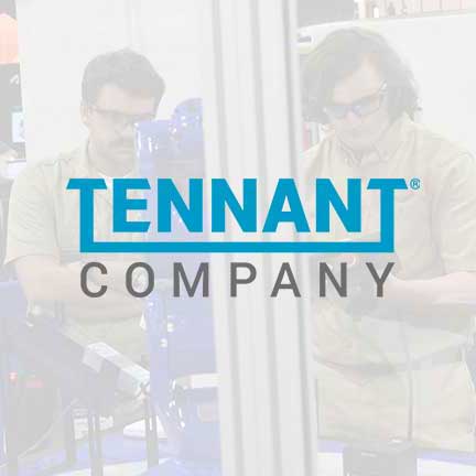 Tennant Company logo with a photo of a robotoics competition behind it.