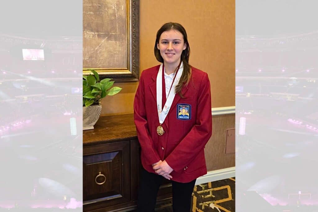 Alexis Squyers wearing red blazer and a gold medal. The photo is over a ghosted skyview image of State Farm arena in Atlanta