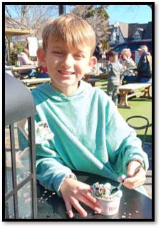 Adam Schoolcraft sitting in a park eating ice cream