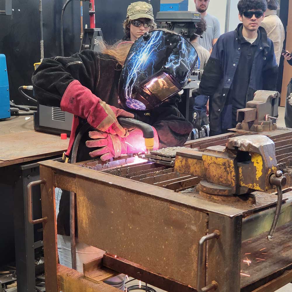 Person welding with sparks flying